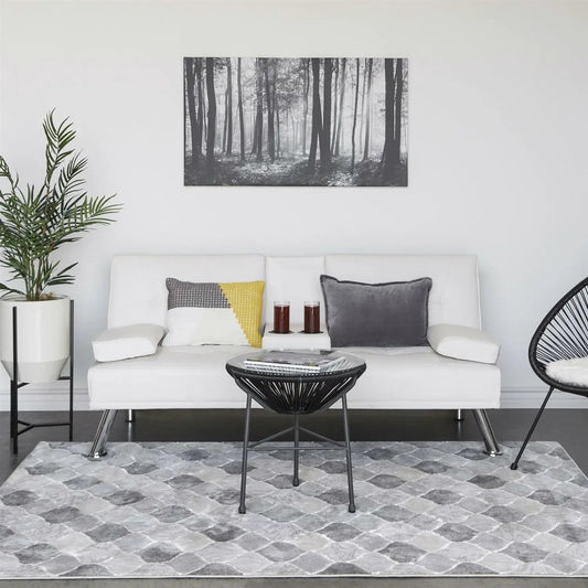 White faux leather convertible sofa futon with metal legs and gray and yellow pillows in living room on Tampa Home & Garden Store