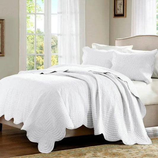 King size reversible scalloped quilt set in white with microfiber fabric on bed on Tampa Home & Garden Store