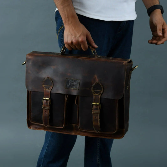 Wall Street Briefcase Leather Messenger Bag in dark brown leather with brass buckles, carried by man on Tampa Home & Garden Store