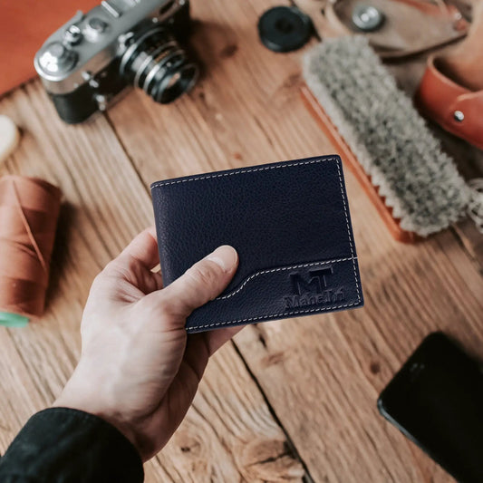 Slim bi-fold wallet navy blue leather with ID slot and card slots, stitched edges on Tampa Home & Garden Store