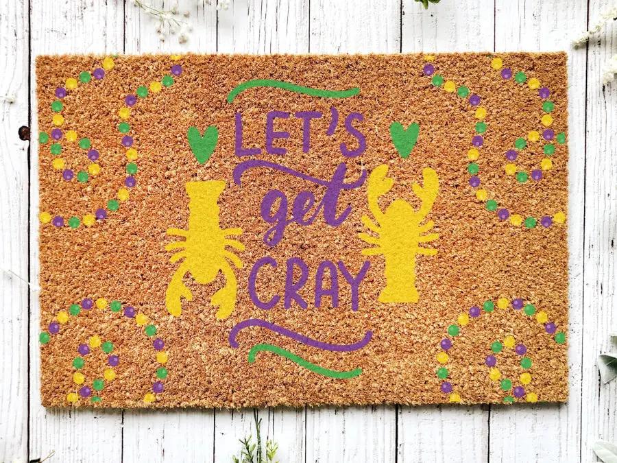 Door Mat Welcome Mardi Gras doormat in brown coir with purple letters and green/yellow accents on Tampa Home & Garden Store