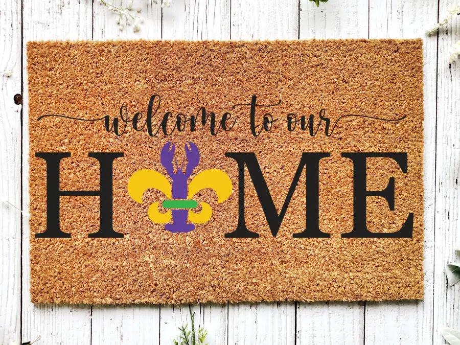 Door mat welcome to our HOME with purple Mardi Gras fleur-de-lis on natural coir 18x30 on Tampa Home & Garden Store