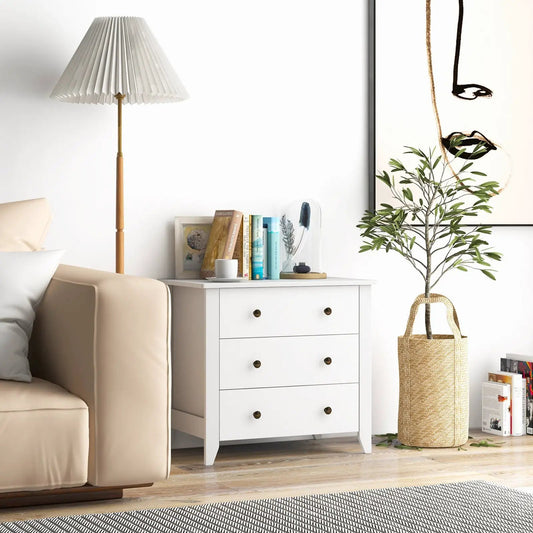 White 3-drawer dresser with brass knobs in a bright living room beside a beige sofa on Tampa Home & Garden Store