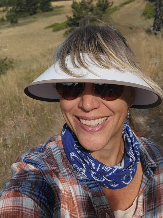 EquiVisor Sport sun visor 4.5in & 3in brim, white top worn by smiling woman outdoors on Tampa Home & Garden Store
