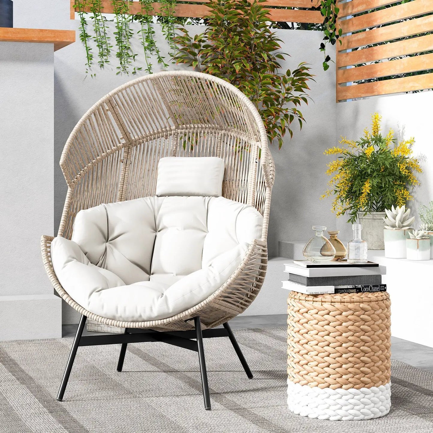 Round wicker papasan chair with white cushions on black metal legs, patio plants and books on Tampa Home & Garden Store