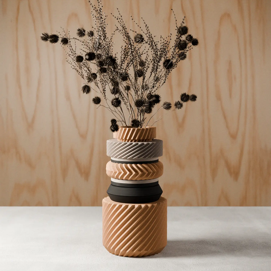 Wonder Vase stacked ceramic vases with bold ribbing in peach and gray; dried thistle bouquet on Tampa Home & Garden Store