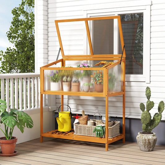 Orange wood cold frame greenhouse with open roof on a porch filled with potted flowers on Tampa Home & Garden Store