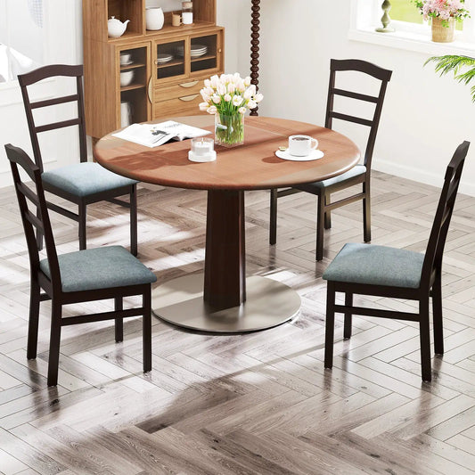Wooden dining chairs with linen upholstery surround a round table, four chairs visible on Tampa Home & Garden Store