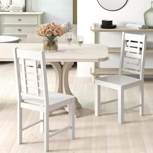 Solid rubber wood dining chairs set of 2 in white with ladder backs around a wood table on Tampa Home & Garden Store