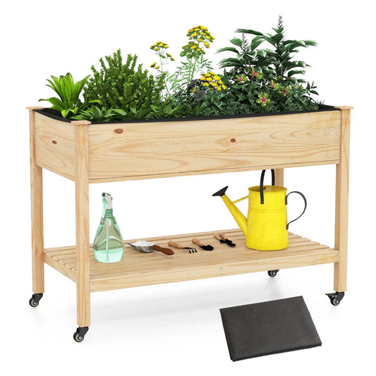 Wooden raised garden bed with legs and wheels, natural wood finish and filled with greenery on Tampa Home & Garden Store