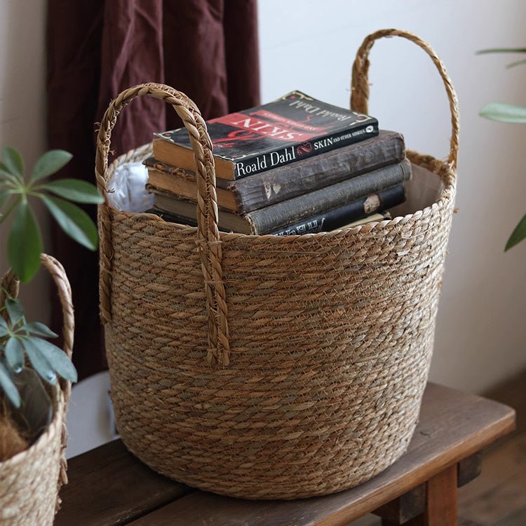 Handwoven seagrass planter basket with handles, natural tan, filled with books RusticReach on Tampa Home & Garden Store