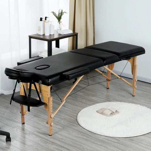 Black adjustable portable massage tattoo table with folding wooden legs and padded surface on Tampa Home & Garden Store