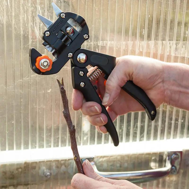 Zenport Grafting Tool Omega Style 2 in 1 with black handles and orange knob used on twig on Tampa Home & Garden Store