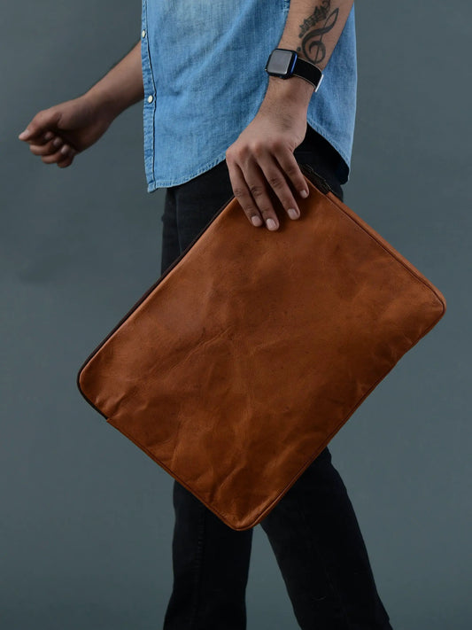 Zento leather laptop sleeve tan brown held by a person wearing a denim shirt on Tampa Home & Garden Store