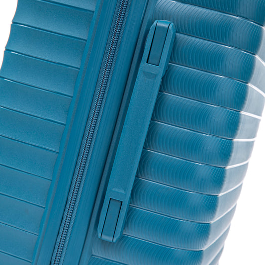 Blue hard-shell luggage close-up showing zipper and ribbed panels on Tampa Home & Garden Store