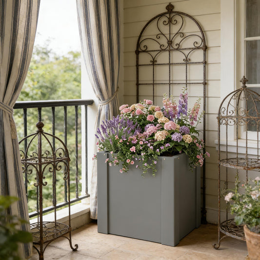 Balcony planter bed planter box in gray with pink and lavender flowers on striped balcony on Tampa Home & Garden Store