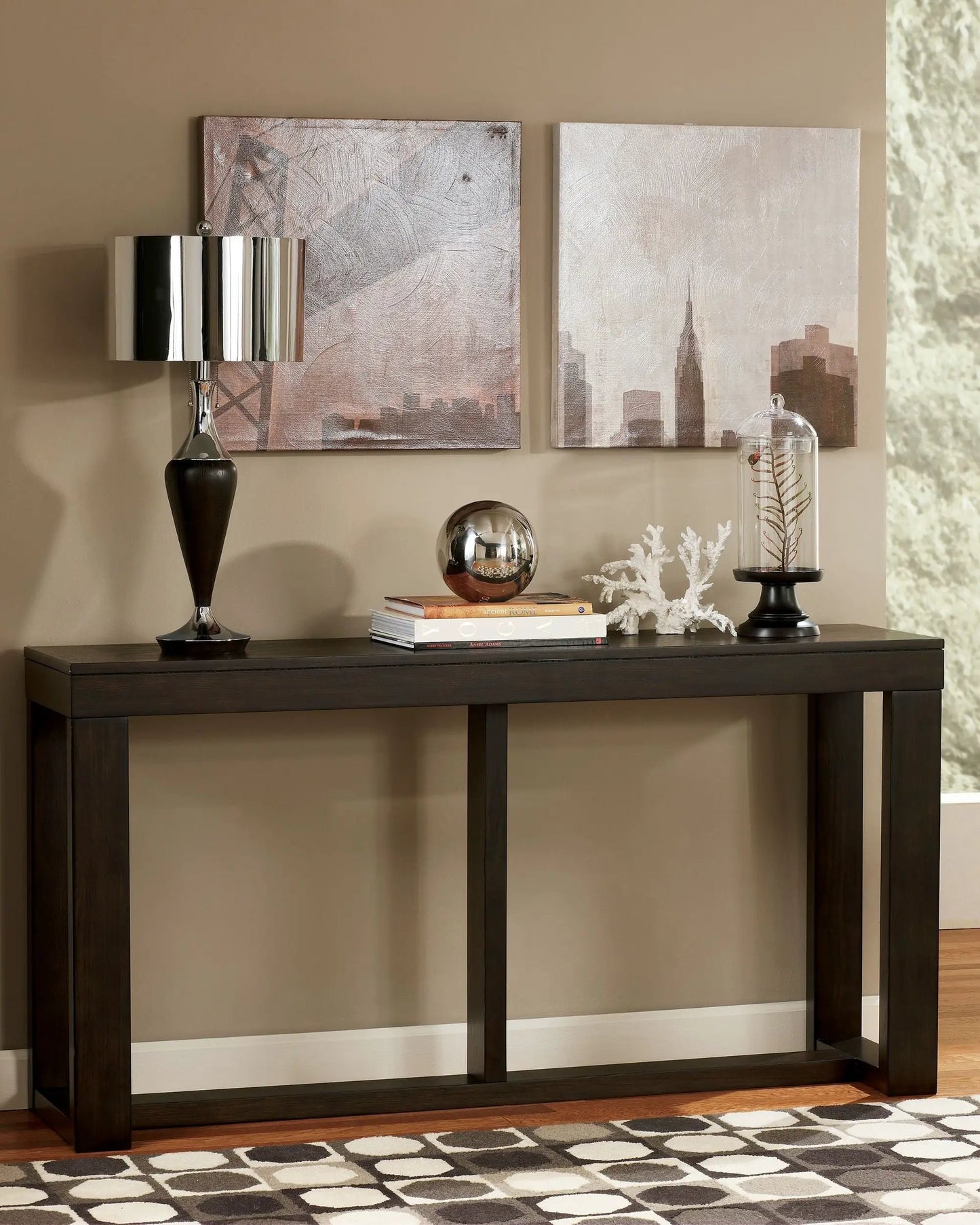 Watson sofa table dark brown wood with thick legs, topped with lamp and decor on Tampa Home & Garden Store