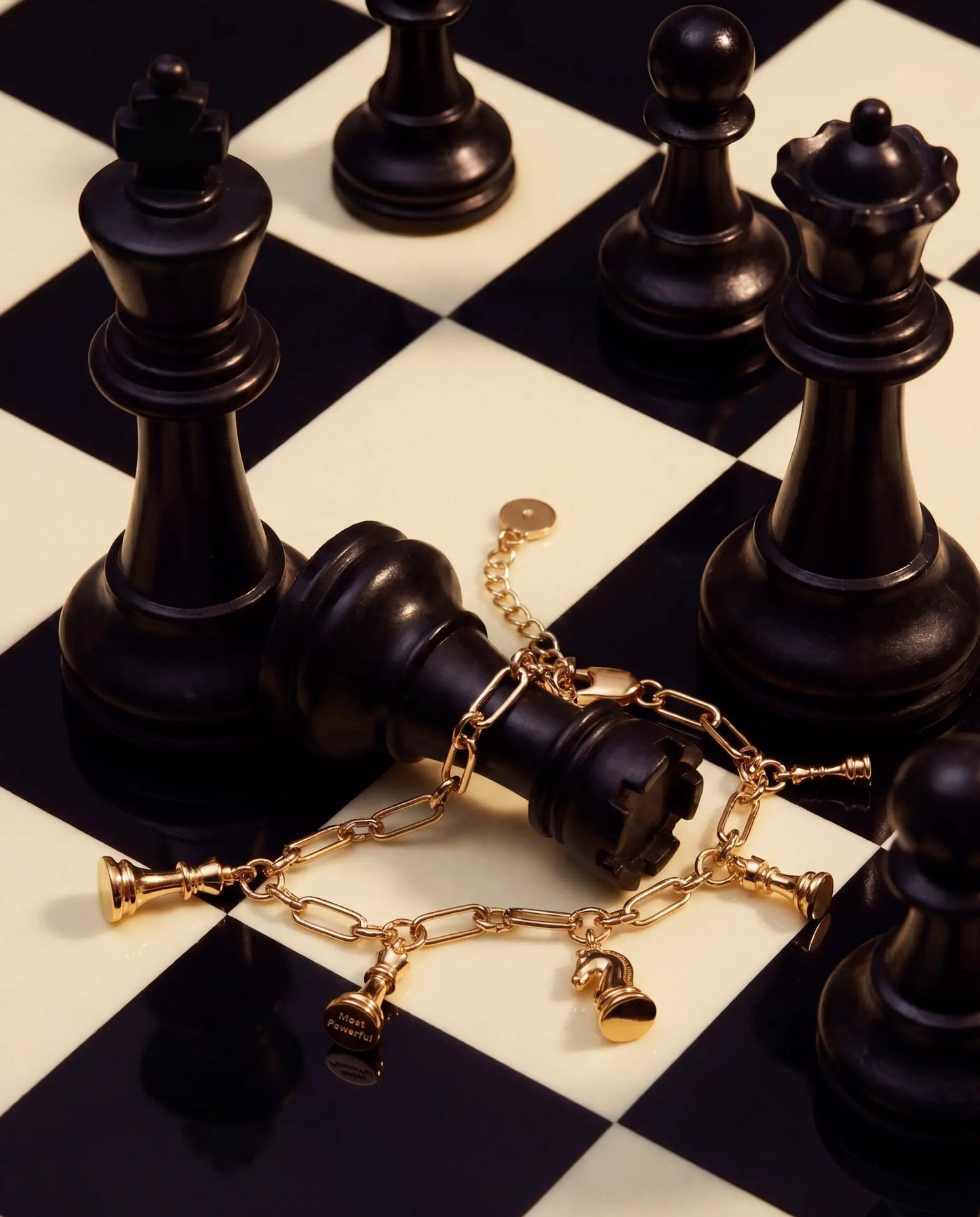 Chess Charm Bracelet by ALEX AND ANI on a black chessboard with gold-tone chain charms on Tampa Home & Garden Store