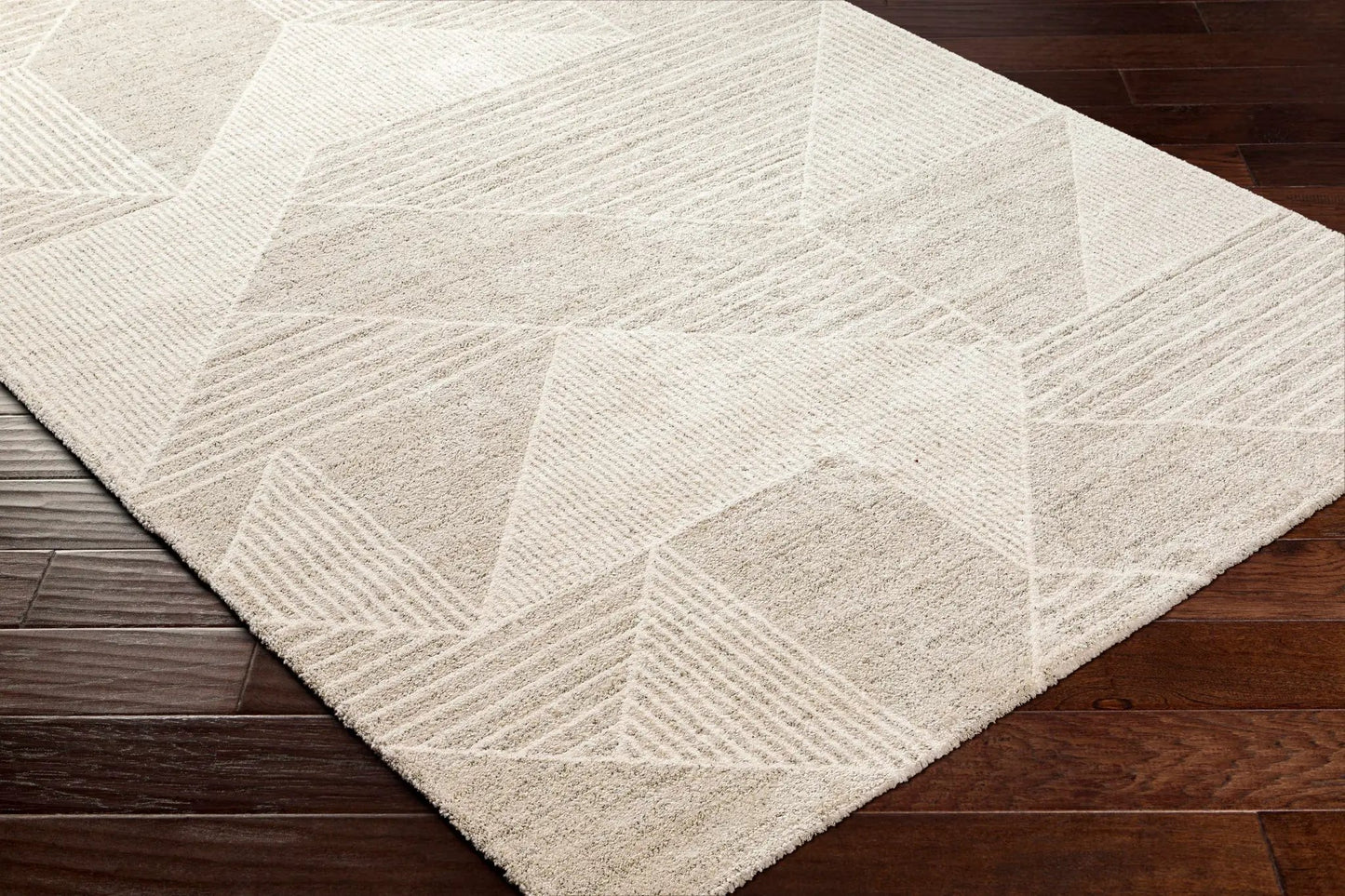 Almas Luxe Rug ivory beige gray with geometric patchwork and textured pile on wood floor on Tampa Home & Garden Store