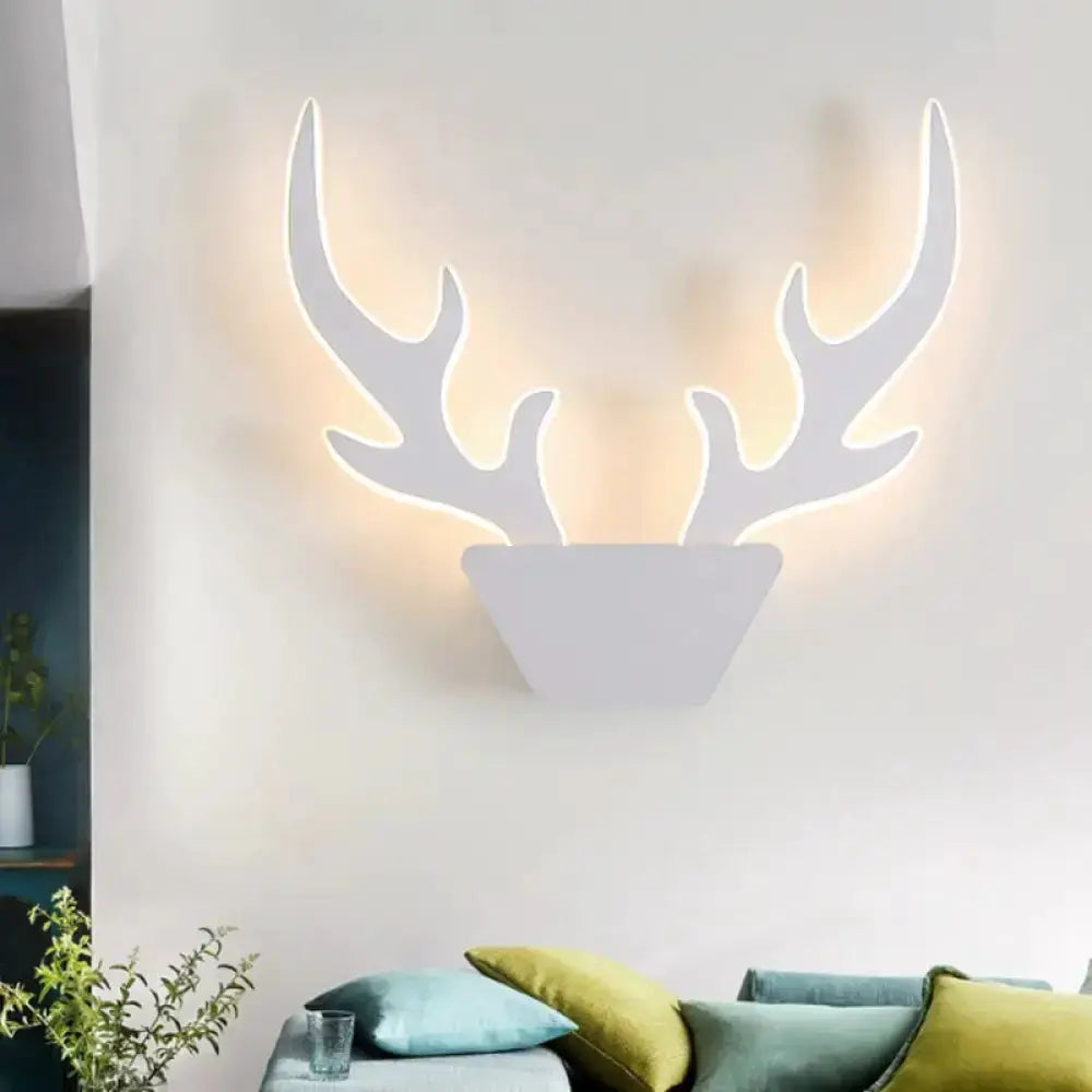 Art deco antler wall sconce Decorbites white finish with warm backlit glow on Tampa Home & Garden Store