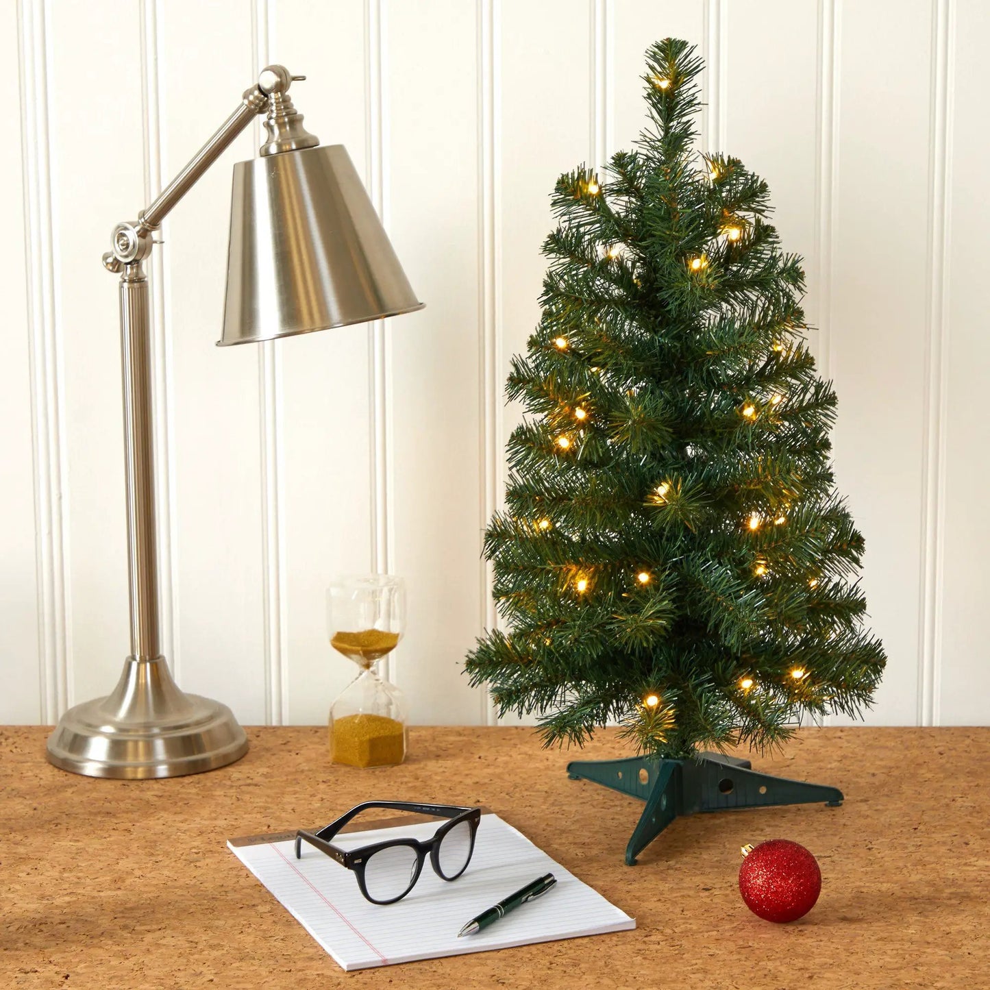 Nearly Natural 2 ft green artificial Christmas tree with LEDs on cork desk beside a silver lamp on Tampa Home & Garden Store