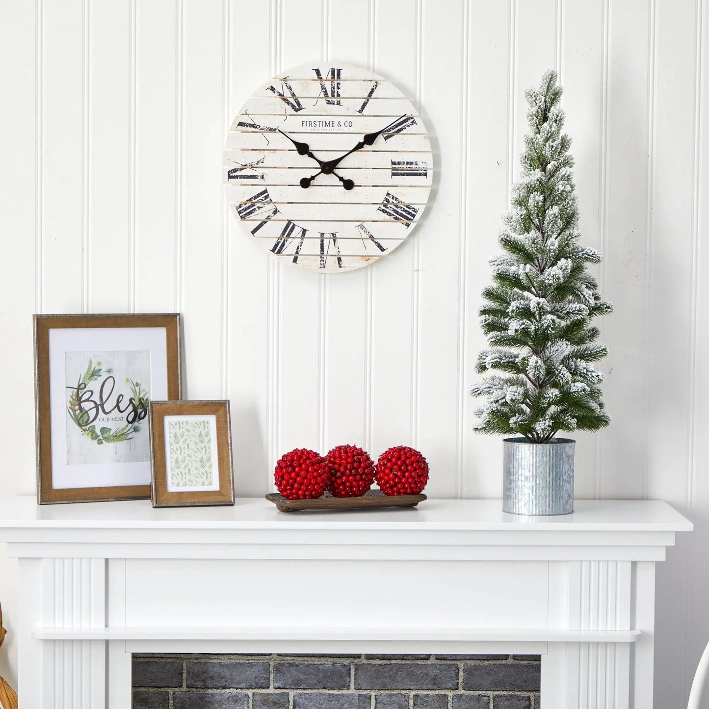 Flocked artificial Christmas tree in tin planter with snow-dusted green branches on Tampa Home & Garden Store