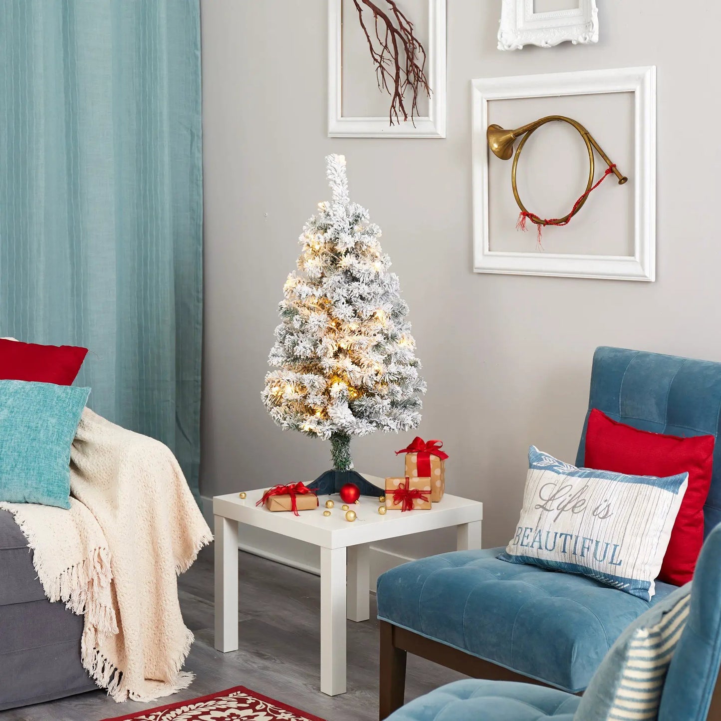 Three foot flocked Rock Springs Spruce Christmas Tree with warm LED lights and gifts on Tampa Home & Garden Store