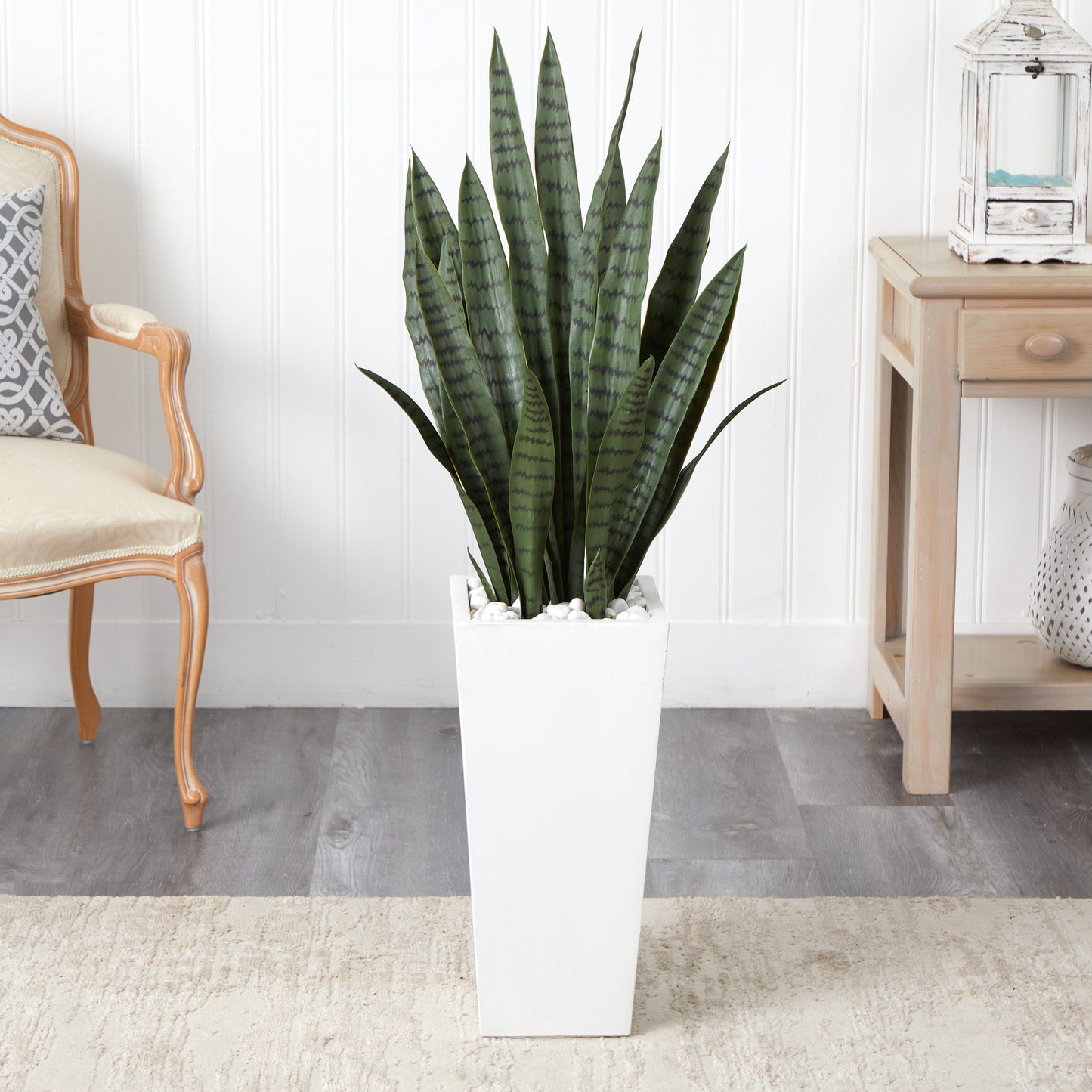 4’ Sansevieria artificial plant in a white tower planter with white decorative stones on Tampa Home & Garden Store