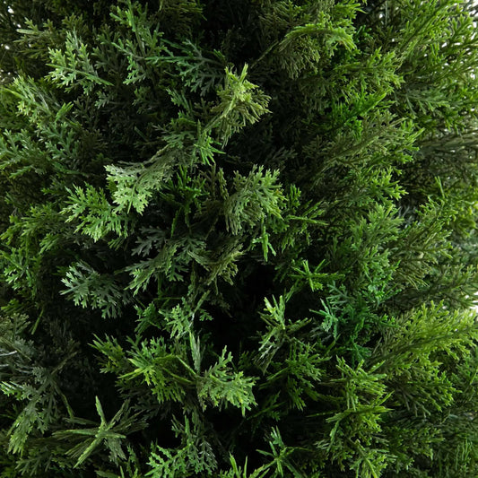 Artificial cedar tree foliage with dense green needles close-up on Tampa Home & Garden Store