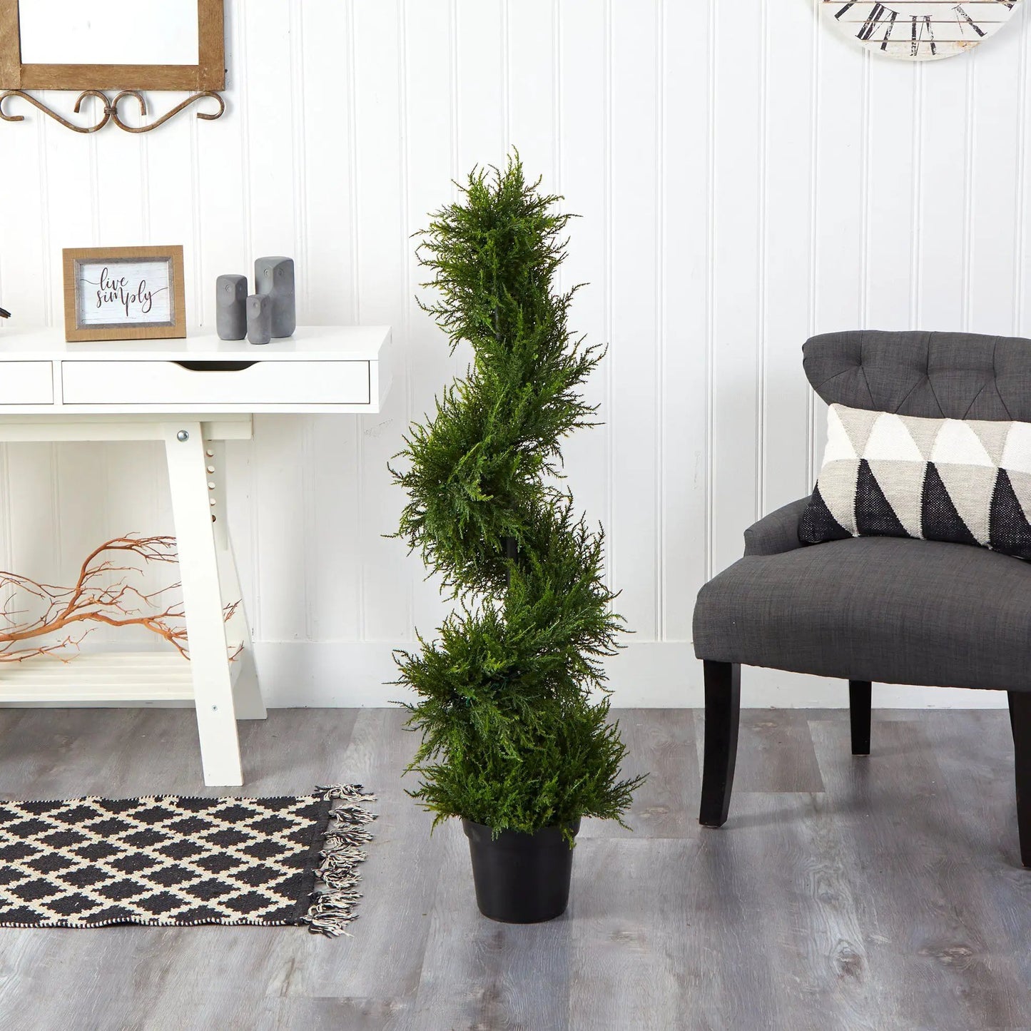45-inch spiral cypress artificial tree in a black planter indoors with white paneled wall on Tampa Home & Garden Store