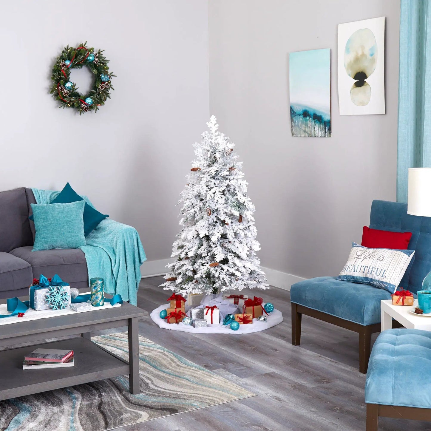 Five Foot Flocked Montana Christmas Tree Lights, white flocked tree in a teal living room with wrapped gifts on Tampa Home & Garden Store