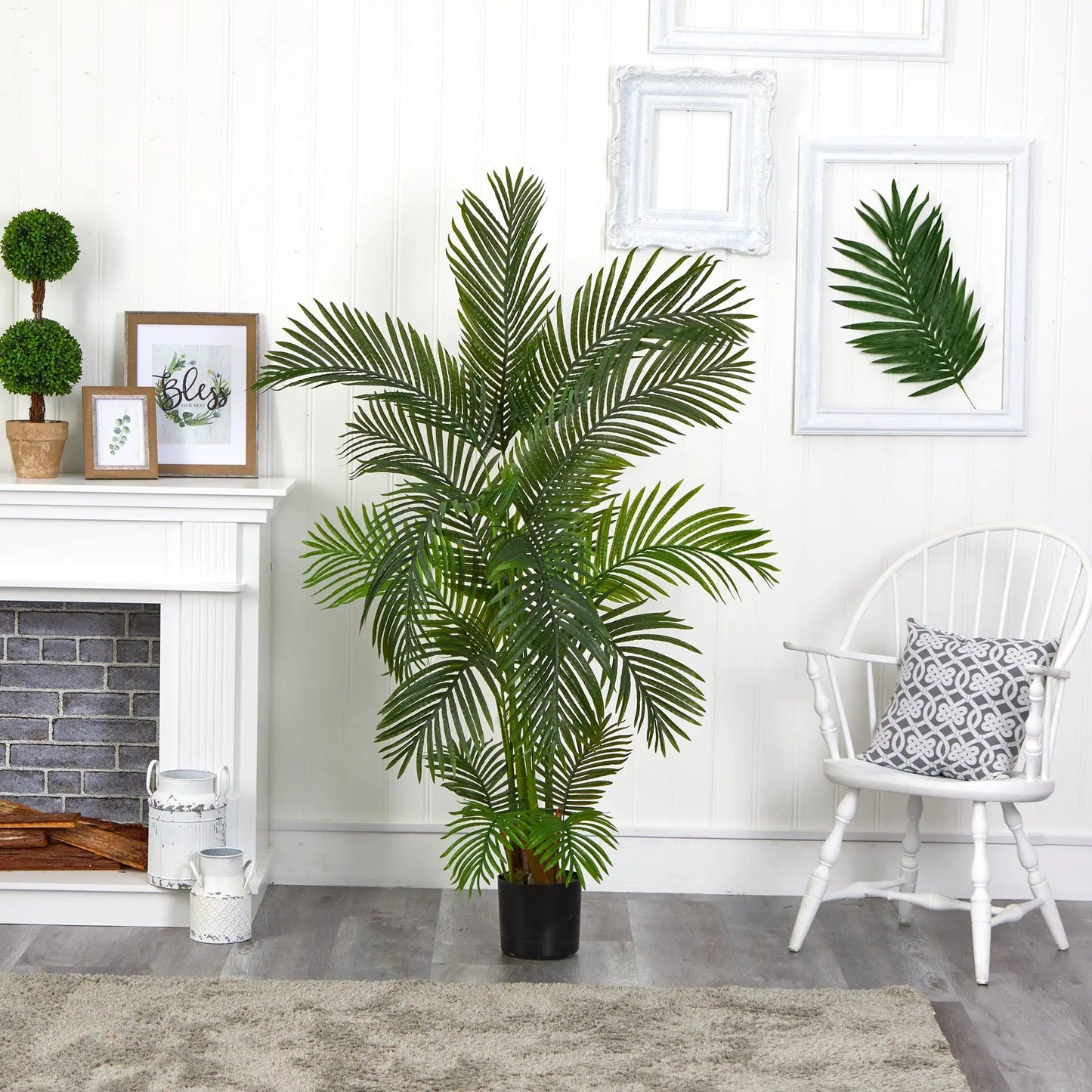 5.5 ft Areca palm artificial tree with lush green fronds in a black pot indoors beside a white paneled wall on Tampa Home & Garden Store