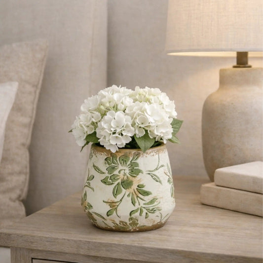 5.5 inch Tuscan ceramic planter with green scroll motif holding white hydrangea bouquet on Tampa Home & Garden Store