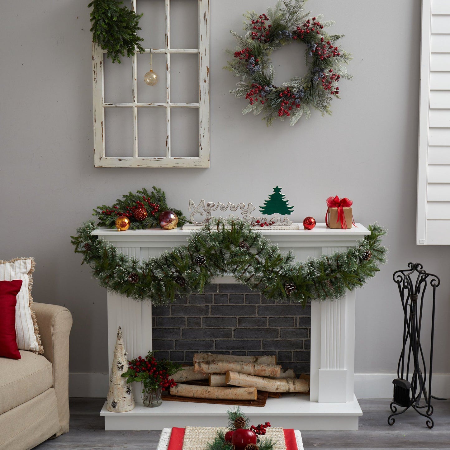 Snow Tipped Garland with pine cones and red berries draped over mantel on Tampa Home & Garden Store