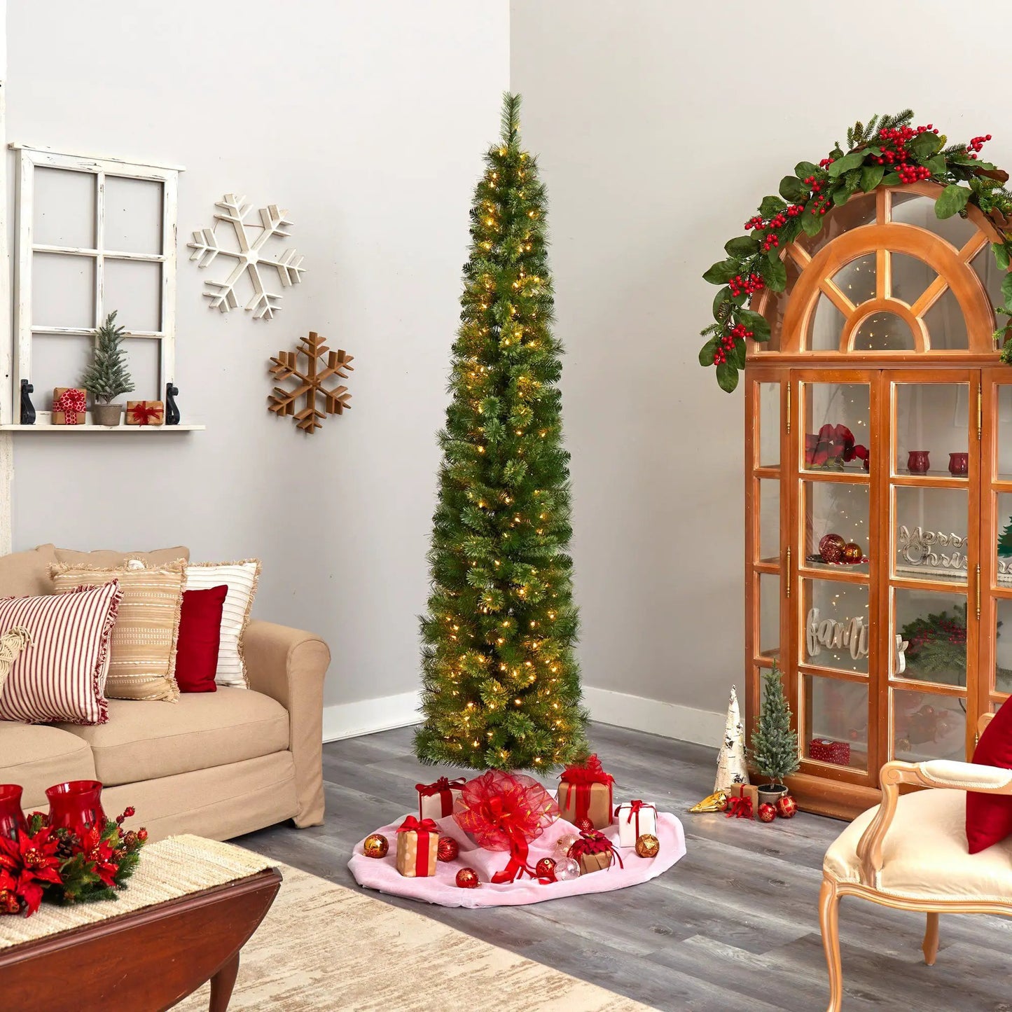 Green pencil Christmas tree, slim artificial with 200 LED lights in a festive living room setup on Tampa Home & Garden Store