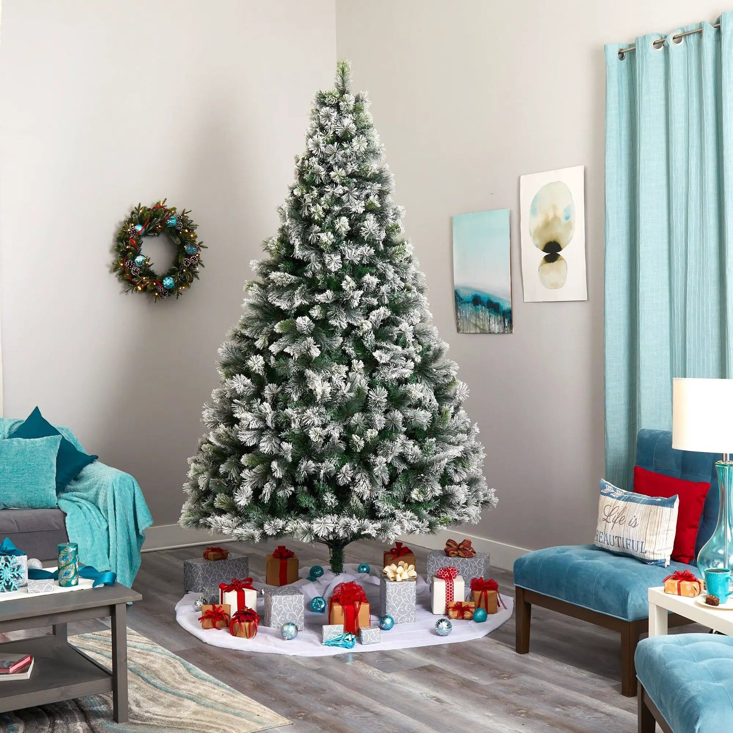 9’ Flocked Oregon Pine Tree with 600 Lights in a cozy living room on Tampa Home & Garden Store