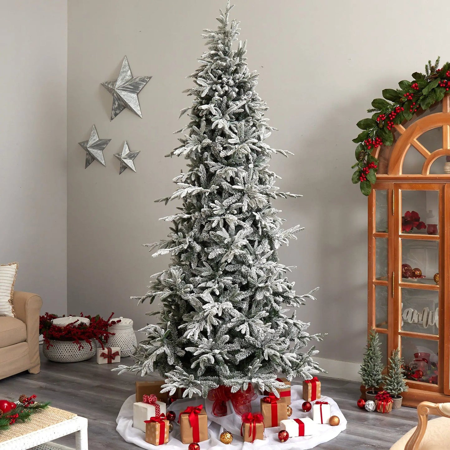 9.5 ft flocked Manchester Spruce artificial Christmas tree with branches in a living room on Tampa Home & Garden Store