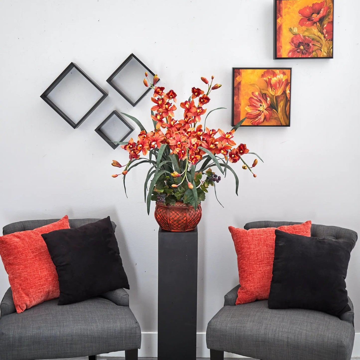 Silk cymbidium floral arrangement in decorative red woven vase with vivid orange blooms on Tampa Home & Garden Store