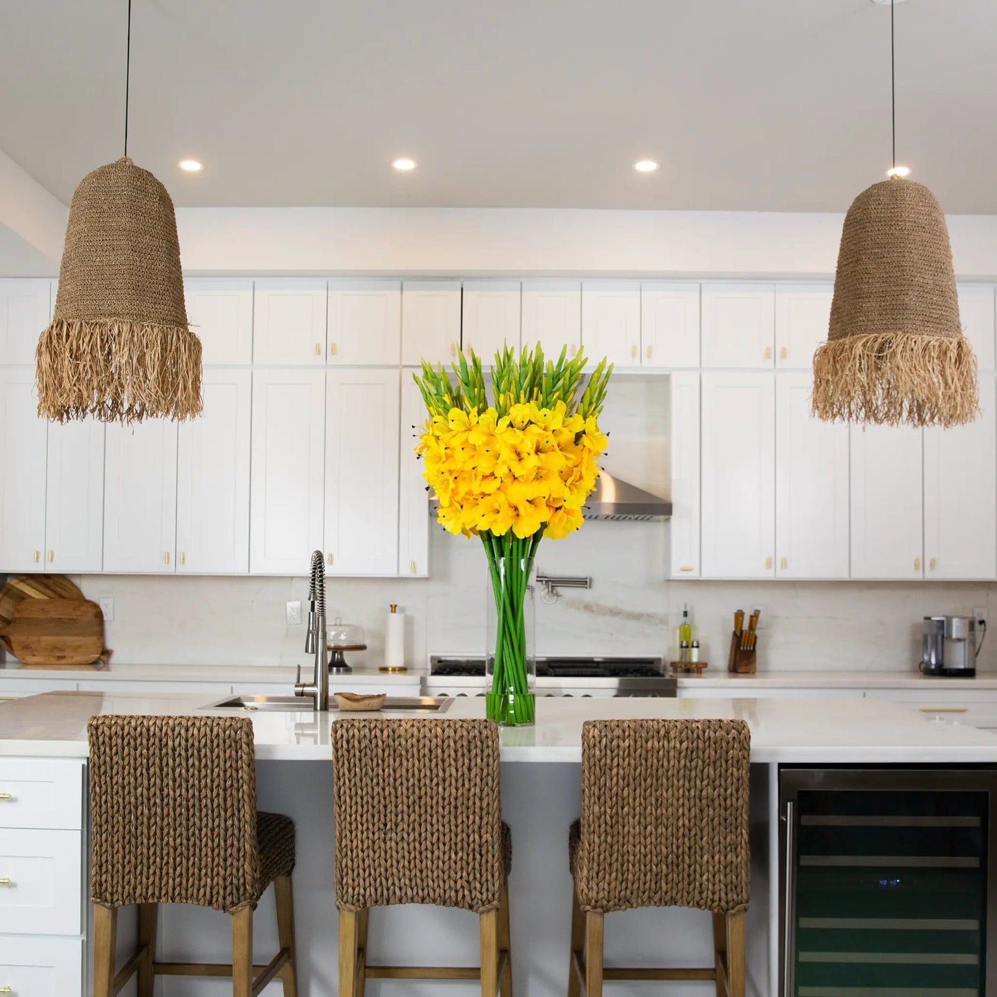 Gladiola artificial arrangement in glass vase with bright yellow flowers on kitchen island on Tampa Home & Garden Store