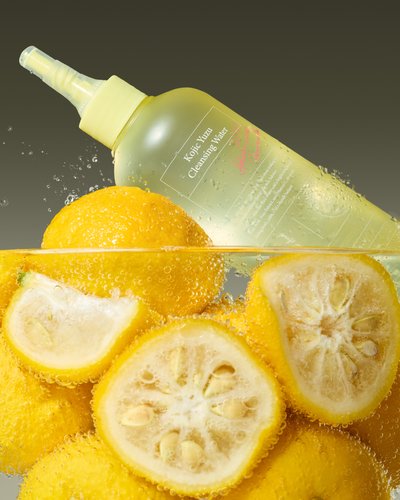Cleansing Water AXIS-Y Kojic Yuzu 250ml bottle with yellow spray surrounded by fresh lemons on Tampa Home & Garden Store