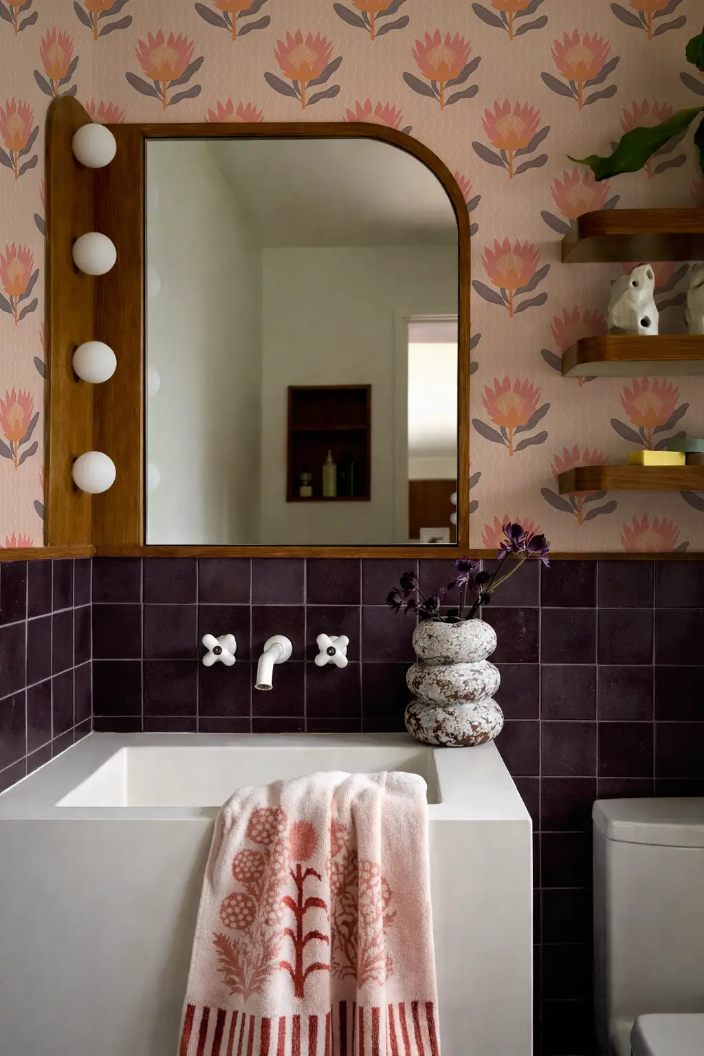 King Protea Wallpaper in coral and orange by Samantha Santana Creative with a framed mirror on Tampa Home & Garden Store