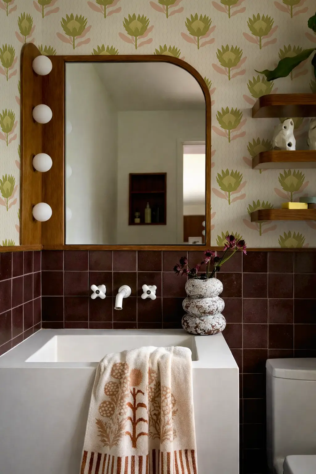 King Protea wallpaper in tan and olive with bold botanical motifs on bathroom wall on Tampa Home & Garden Store