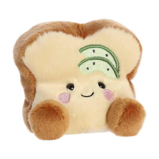 Brittany Avocado Toast Palm Pal plush toy, avocado toast patch on chest, soft tan fur on Tampa Home & Garden Store