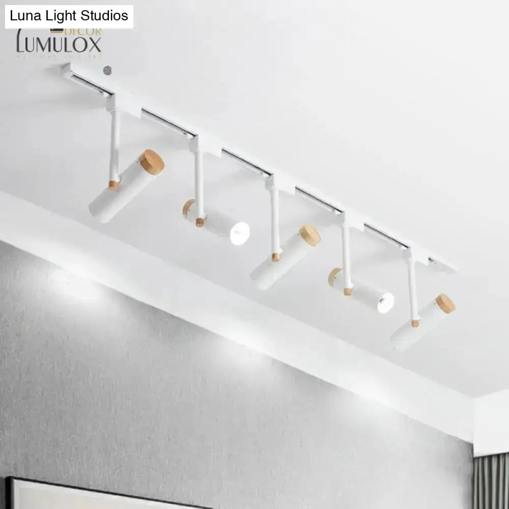 Ceiling track lighting fixture with white cylindrical heads and wood accents on Tampa Home & Garden Store