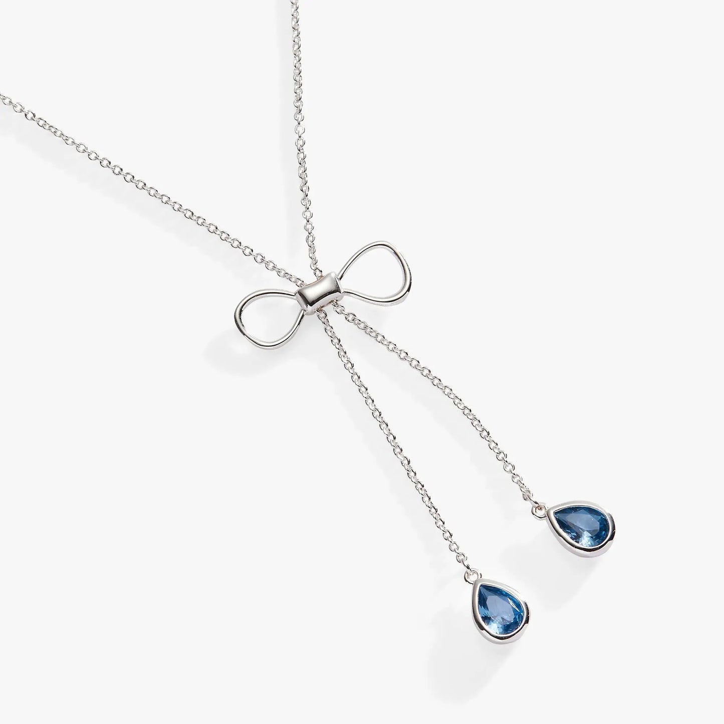 Bow adjustable slider necklace by Alex and Ani with a silver bow charm and blue teardrop pendant on Tampa Home & Garden Store