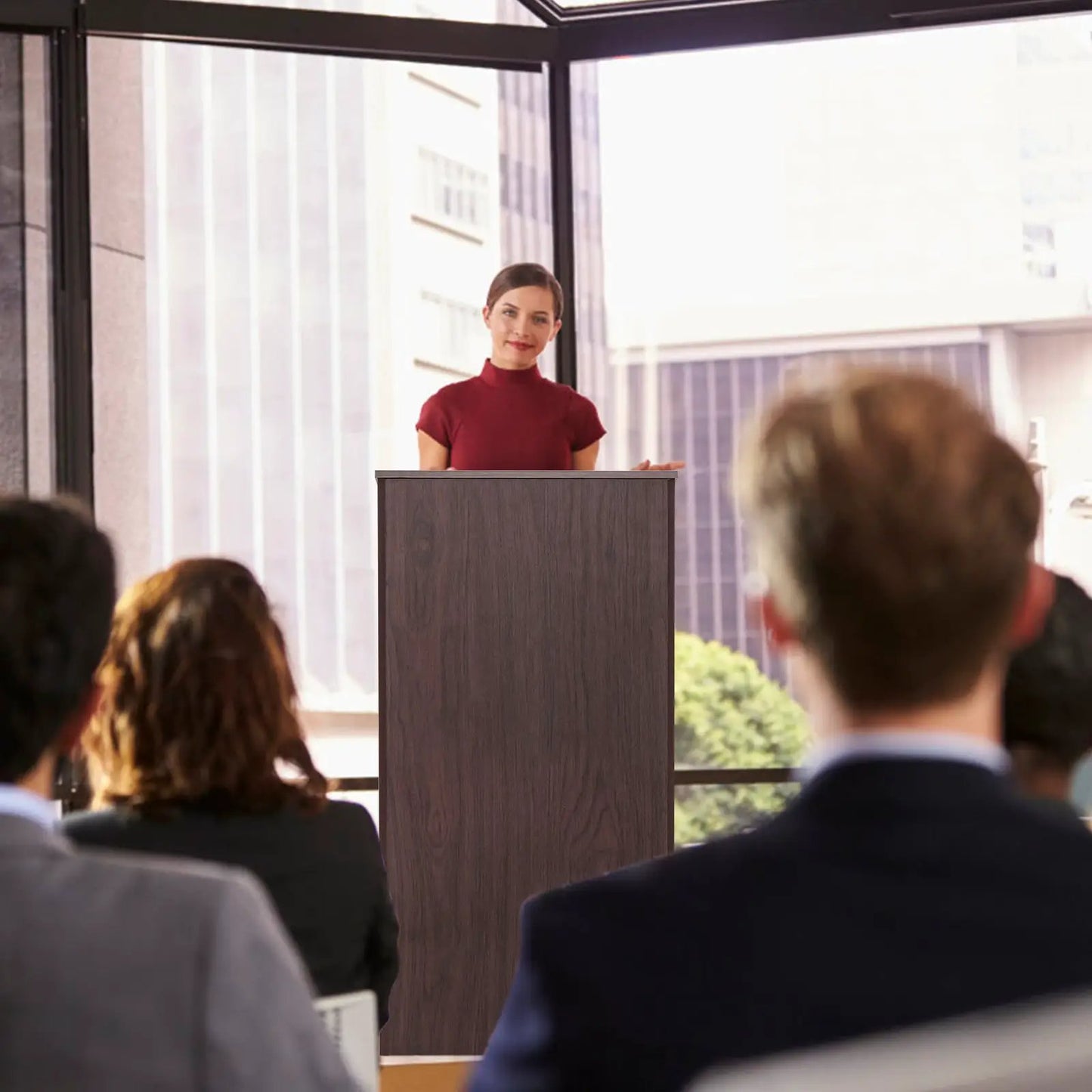 Wooden floor-standing lectern in dark wood with presenter at the lectern and audience on Tampa Home & Garden Store