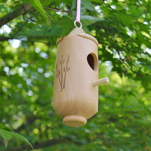 Wooden hummingbird hanging nest house with a small perch, natural wood finish and carved branch on Tampa Home & Garden Store
