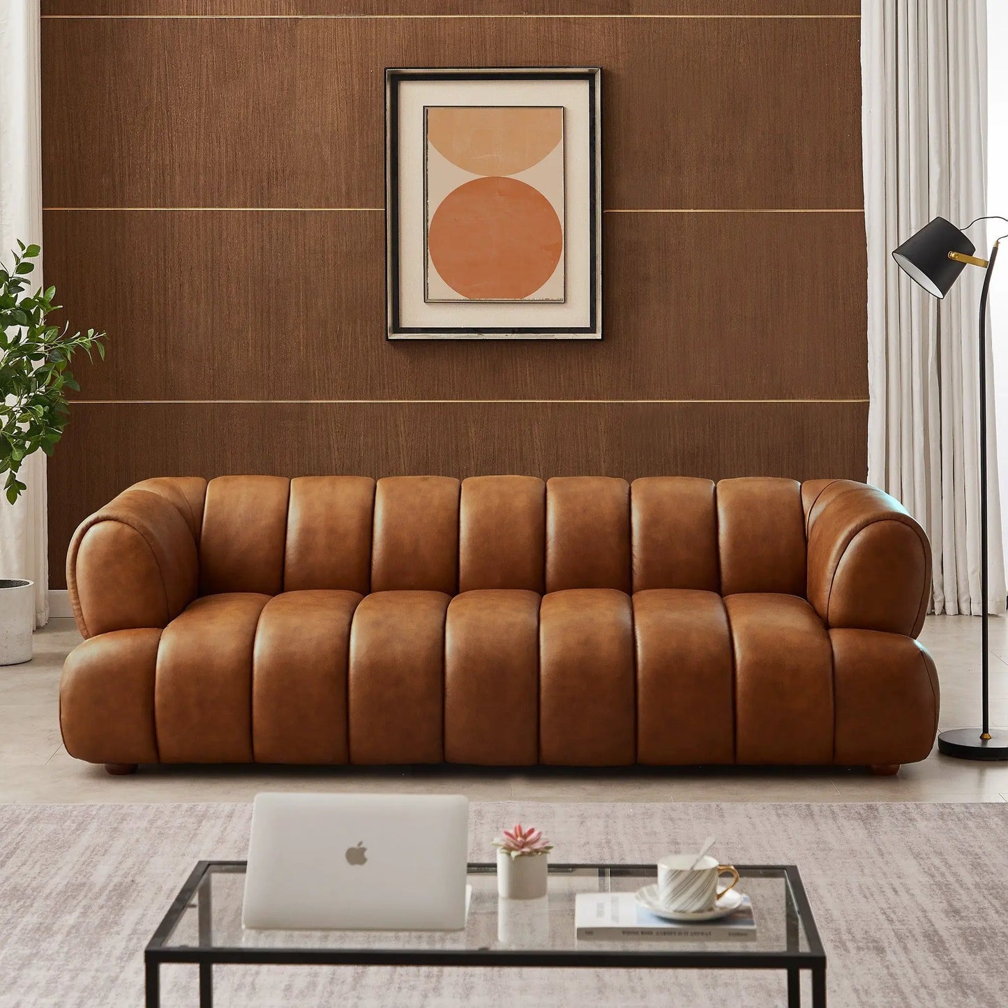 Jasmin Elegant Upholstered Sofa, tan brown leather with tufted arms in a living space on Tampa Home & Garden Store