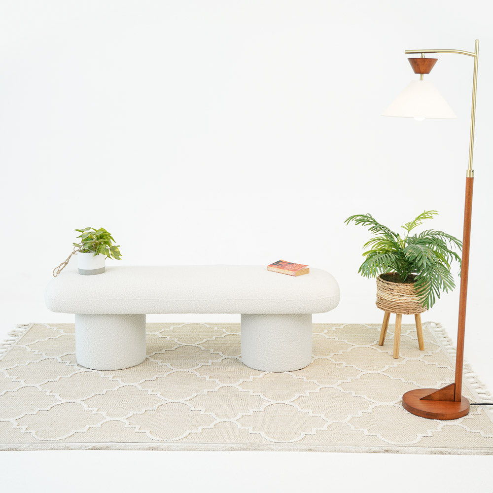 Ivory boucle upholstered bench Randolph by HouseOfZazla with two cylindrical legs on a beige rug on Tampa Home & Garden Store