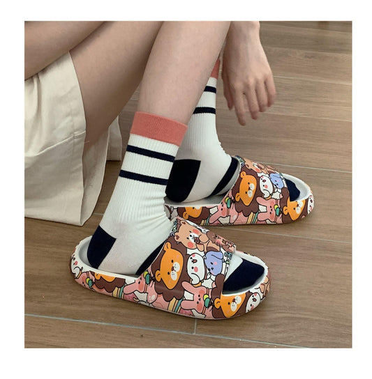 Cartoon bear slide sandals with thick sole and bear print, worn with white striped socks on Tampa Home & Garden Store
